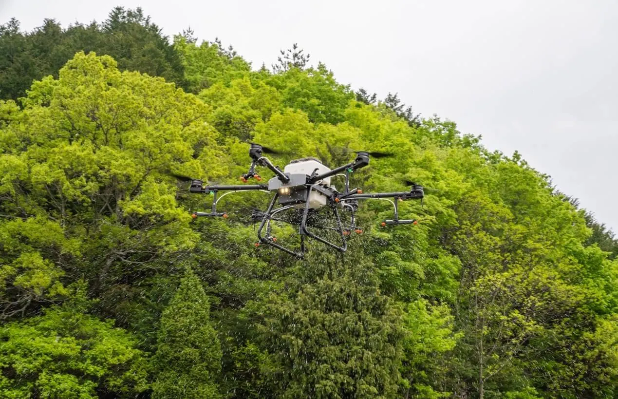 Agras drone flying among trees